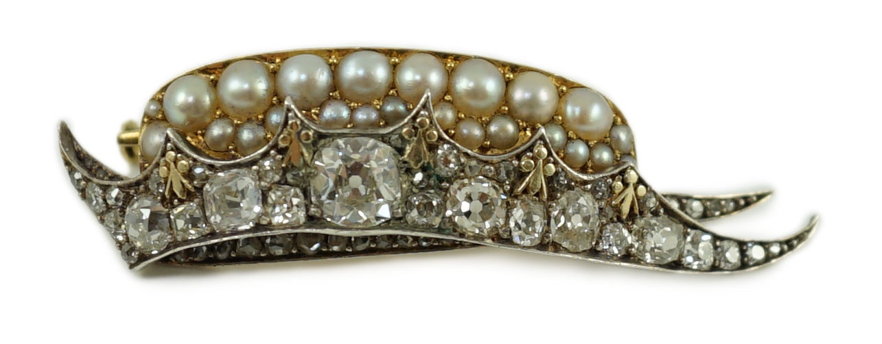 A Victorian gold and silver, diamond and split pearl set brooch, modelled as a 'chapeau gules turned up ermine' or heraldic cap of maintenance